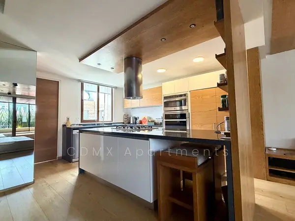 Open kitchen with island and wood-paneled ceiling